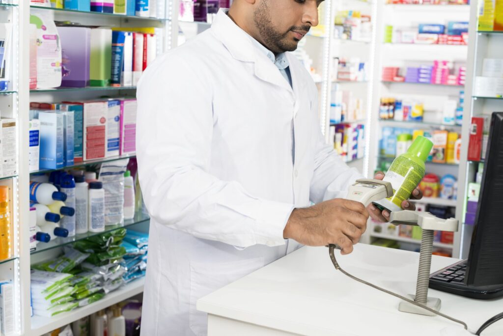 Pharmacist Scanning Product at Computer